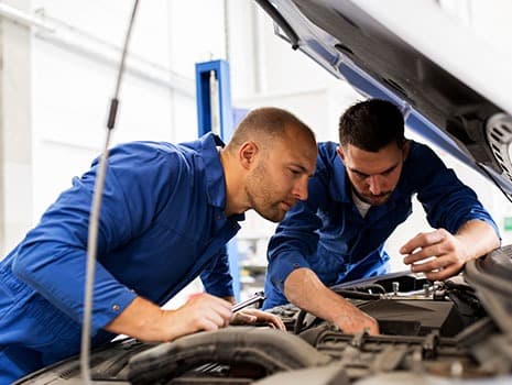 Technicians working on vehicle maintenance
